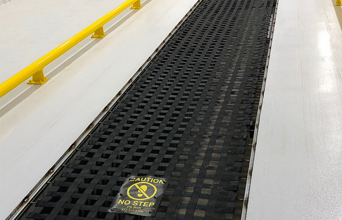 Pit Bull heavy-duty yellow pit safety cover installed over a quick lube bay for OSHA compliance